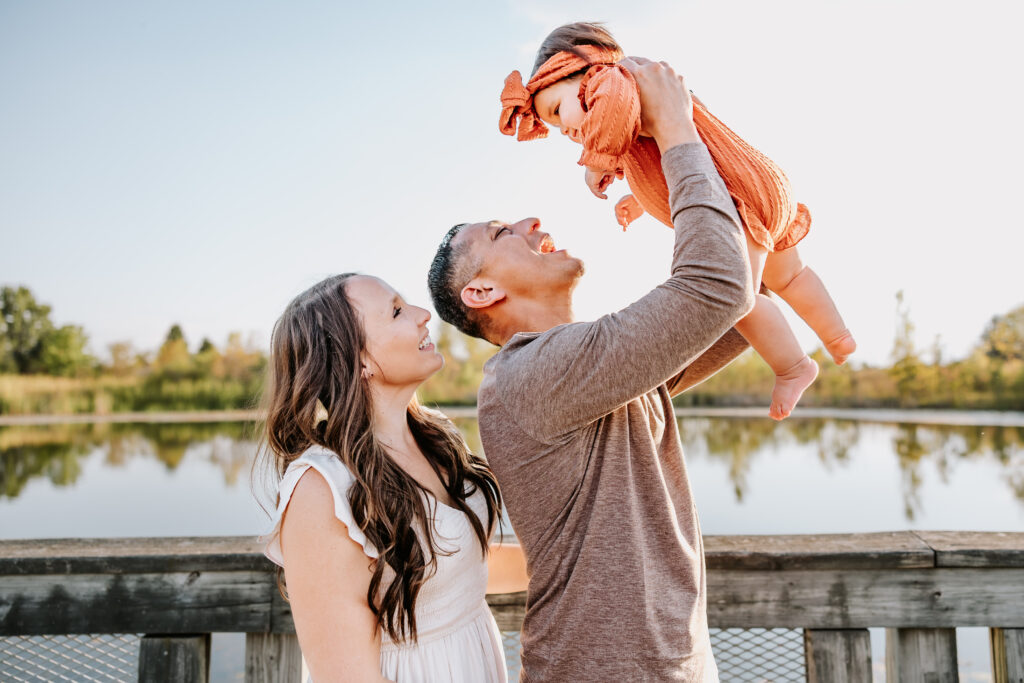 Parents at West Park in North Indy posed next to the water with their one year old baby