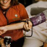 Home birth midwife in Indy checking vitals at a home birth