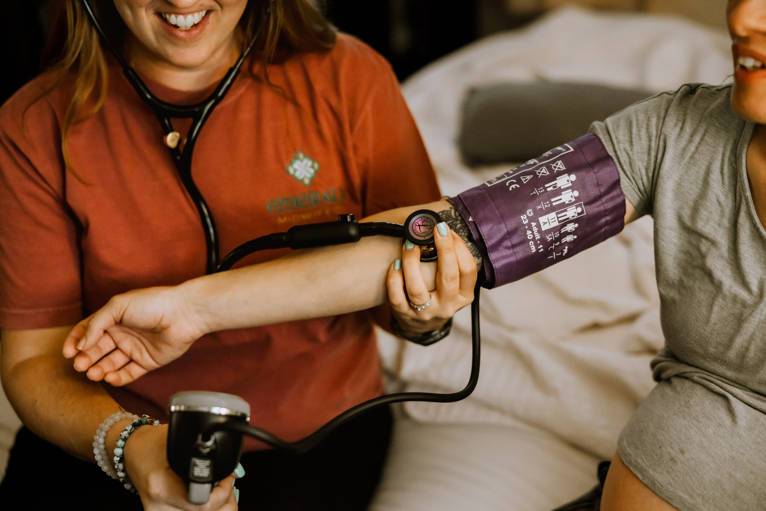 Home birth midwife in Indy checking vitals at a home birth